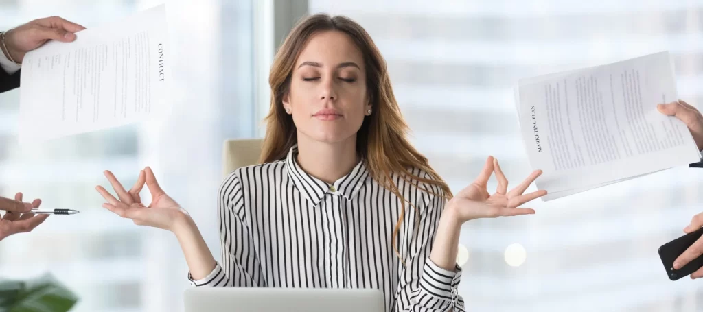 professional woman meditating at desk