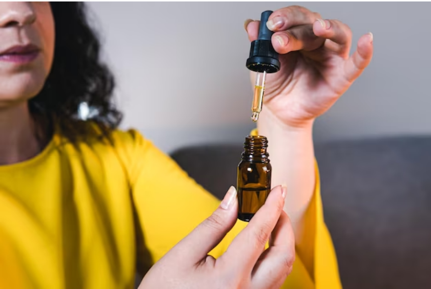 woman taking CBD oil 