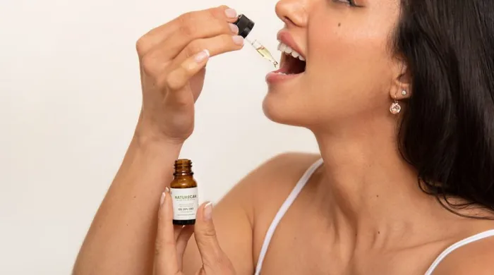 woman taking CBD oil