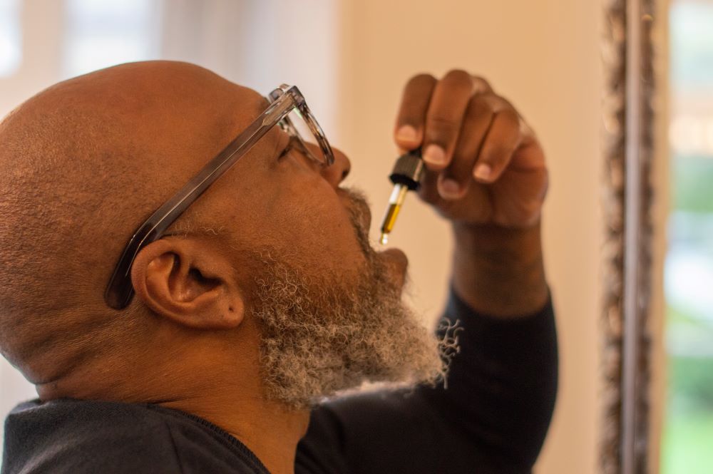 old man ingesting CBD
